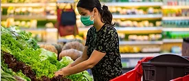 woman in the produce section at the grocery store