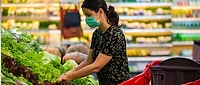 woman in the produce section at the grocery store