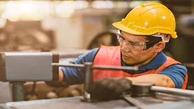 Worker in refrigerated food facility.