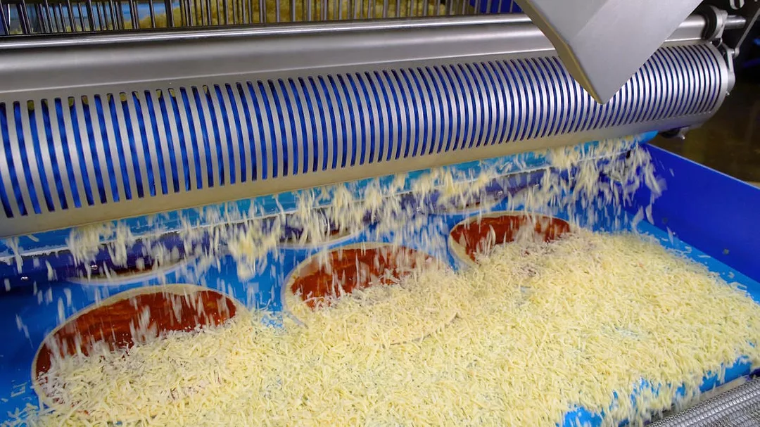 Grote’s Waterfall Topping Applicator met the challenge perfectly. The applicator provides accurate cheese and IQF topping distribution and weights with less than 1% floor waste. 