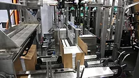 A side-load case packer A side-load case packer