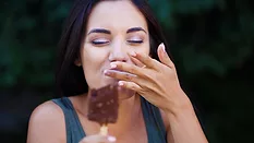 Woman eating an ice cream bar