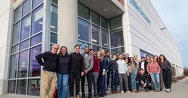 Little Sesame staff standing outside at the opening of its new facility in Capitol Heights, Maryland with a ribbon-cutting ceremony.