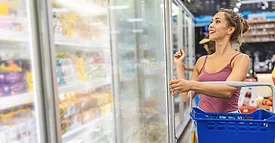 Woman shopping freezer isle