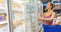 Woman shopping freezer isle