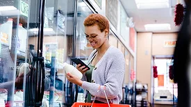 women looking at label in dairy section