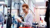 women looking at label in dairy section
