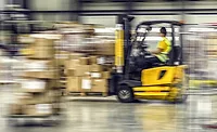 Blurred motion of forklift in warehouse
