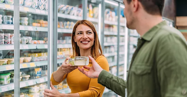 Couple shopping in refrigerated food section