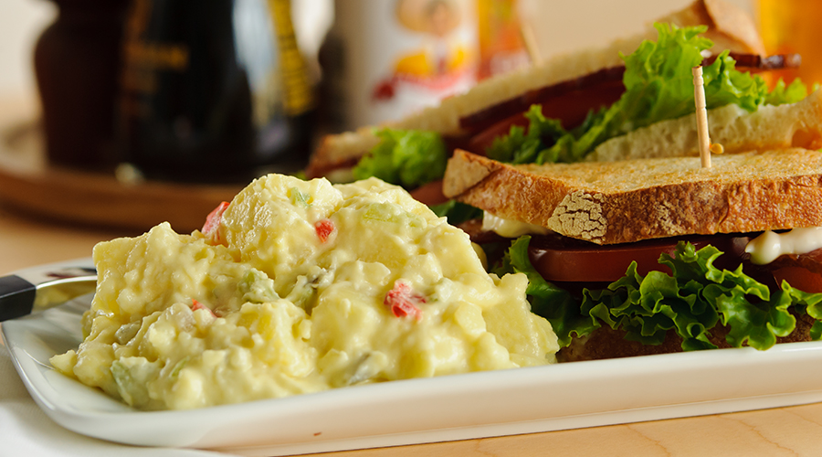 Potato salad and sandwich on plate