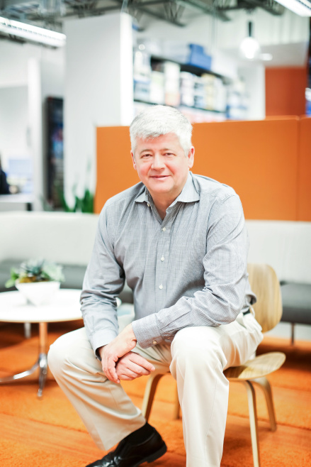Michael Cody, Director of the Industrial Cold & Food division at Ware Malcomb. He is sitting on a chair posing for a picture.