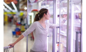 Woman Reaching Frozen Food Grocery Store