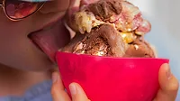 Child eating ice cream Child licking a bowl of ice cream.