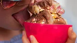 Child licking a bowl of ice cream.