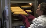 CraftMark operator putting bread in oven 147